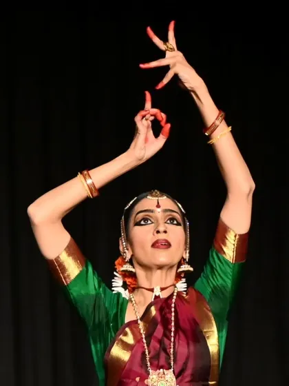 Madhura in a dynamic pose, her arms reaching upwards. Her performance was a highlight of our World Dance Day celebrations.