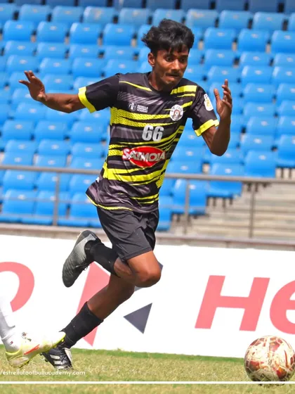 A player from my academy on the move during a Football Delhi B Division league match, played in a professional stadium setting.