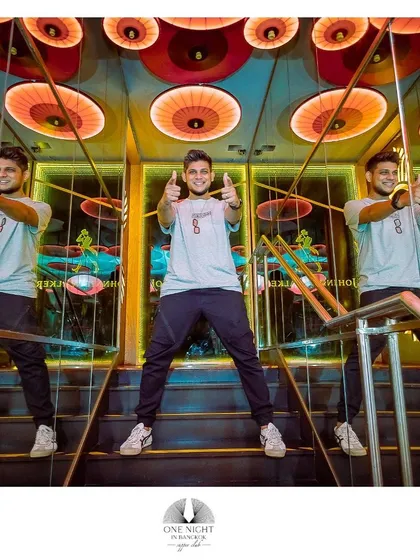 A fun, creative shot of me in a hall of mirrors at a club, showing my playful personality.