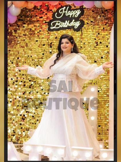 Another shot of the birthday girl in her stunning white gown, showing how it catches the light against the shimmery backdrop.