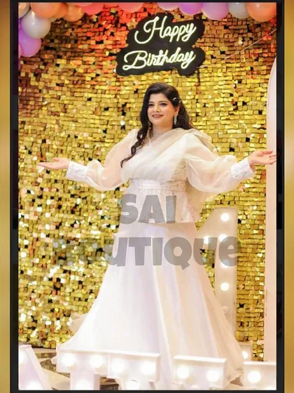 Another shot of the birthday girl in her stunning white gown, showing how it catches the light against the shimmery backdrop.