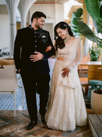 Swati and Sarthak share a laugh as they walk together. This candid moment from their engagement shows their easygoing chemistry and stylish modern-traditional outfits.