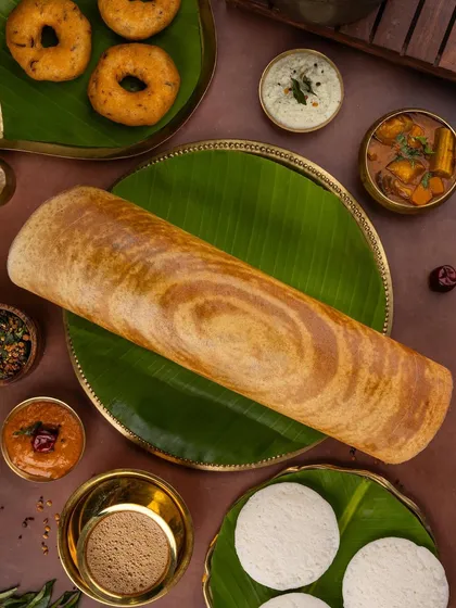 Capturing the heart of traditional food is one of my passions. This South Indian spread, featuring a perfectly crisp dosa, is styled with authentic elements like banana leaves and brassware to evoke a genuine cultural feel.