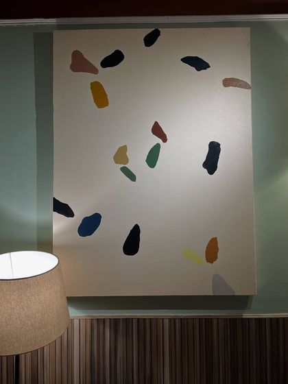 The terrazzo-style painting installed at the Sidewalk cafe in Kanpur. Its playful pattern adds a touch of modern fun to the wall.