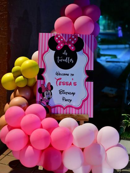 A Minnie Mouse themed welcome board for a second birthday party. The classic pink and black design is fun and instantly recognizable.