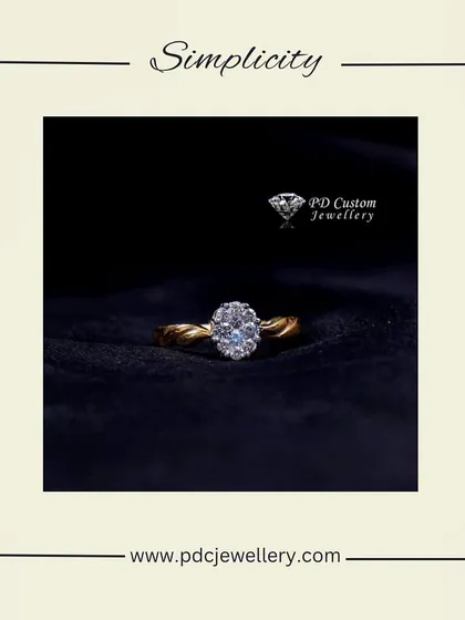 A simple yet beautiful solitaire ring with a twisted band design. The oval-shaped diamond cluster creates a classic look with a modern touch, perfect for an engagement or anniversary.