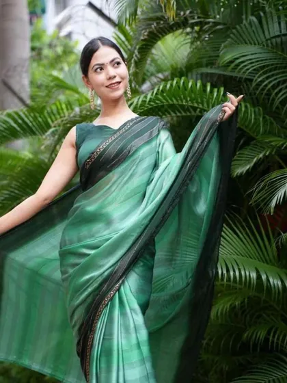 This shaded green saree offers a modern aesthetic with its color gradient. As a pre-stitched saree, it combines contemporary design with the timeless grace of a saree drape.
