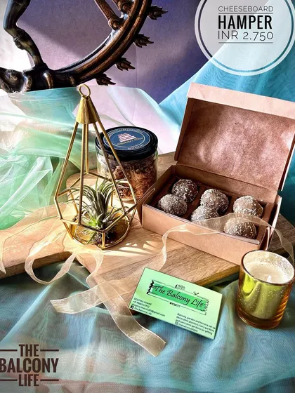 A slightly different take on a platter, this hamper features a beautiful mango wood cheeseboard. It's a versatile gift that can be used long after the festivities are over. We pair it with an air plant, a candle, granola, and a box of delicious upcycled sweets.
