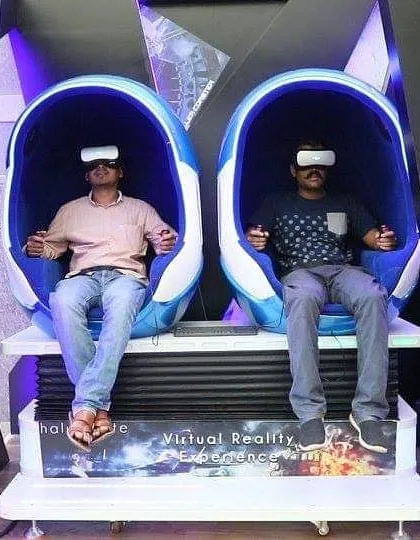 Two guests enjoying a synchronized virtual reality experience in our motion egg pods. These simulators are perfect for virtual roller coasters, space flights, and other thrilling rides that can be enjoyed individually or side-by-side.