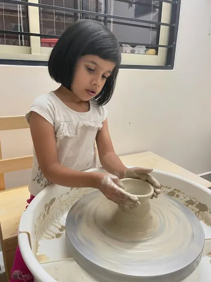 It is pure magic watching our youngest potters discover the joy of clay. This little one is completely focused on the wheel, learning how to shape her very first pot. These moments of discovery are truly precious.