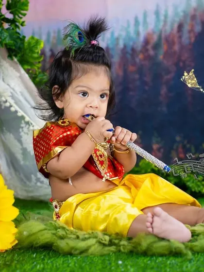 Another adorable little Krishna, enjoying his flute in a lush green setting. The sunflower adds a bright and cheerful pop of color.