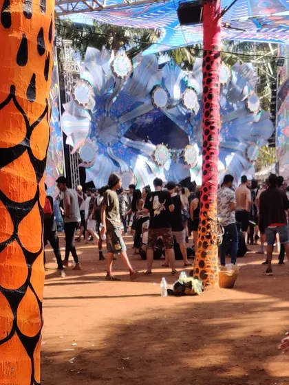 A view of the Hilltop stage through the decorated palm trees. The attention to detail in the decor helps build a completely immersive world.
