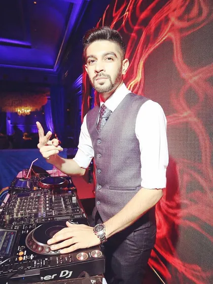 A sharp, professional look for a corporate event. I'm at the decks, ready to provide the soundtrack for the evening, ensuring the music aligns with the company's brand and the event's sophisticated tone.
