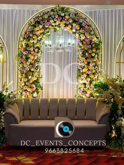 A closer look at the triple-arch reception stage, highlighting the lush floral work and the soft glow of the chandeliers. This setup is perfect for creating a romantic and sophisticated wedding ambiance.
