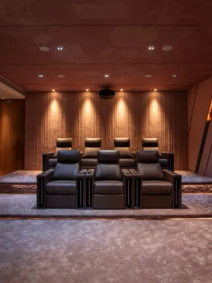 We create bespoke entertainment spaces that are both immersive and stylish. This private home theater features tiered seating, professional-grade acoustics, and dramatic onyx-panel lighting, crafting the ultimate cinematic experience right at home.