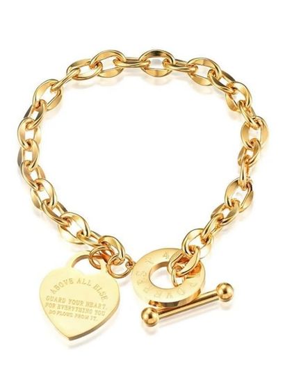This toggle bracelet features a classic link chain and an engravable heart charm. It's a bold and personal piece.