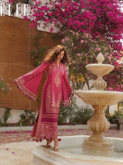 A beautiful, breezy shot from the ELLE India March 2024 cover story. The makeup is warm and radiant, perfect for the outdoor setting and the vibrant pink outfit.