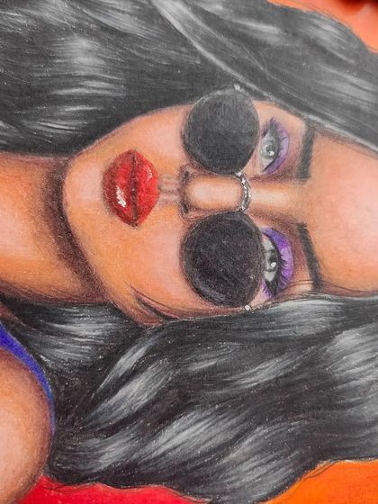 A close-up of the woman's face, focusing on the details of her sunglasses and hair.