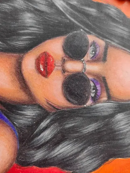 A close-up of the woman's face, focusing on the details of her sunglasses and hair.
