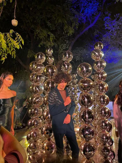 A model poses against a backdrop of disco balls, perfectly capturing the theme of the evening.