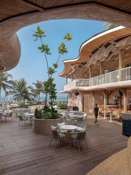 This shot captures the main courtyard of Dubki, framed by the unique cave-like architecture. The design creates a journey of discovery, leading guests from an intimate entrance to this grand, open vista.