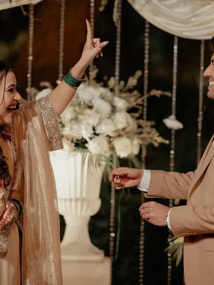 A playful moment during the ring ceremony, capturing the fun and excitement of this special milestone in an intimate setting.