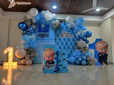 A fun Boss Baby theme for a first birthday, using a blue and white color scheme with character cutouts and themed backdrops.