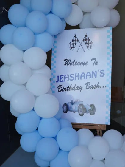 A classic race car theme for Jehshaan's birthday bash. The checkered flag motif and vintage car graphic create a cool, retro racing vibe.