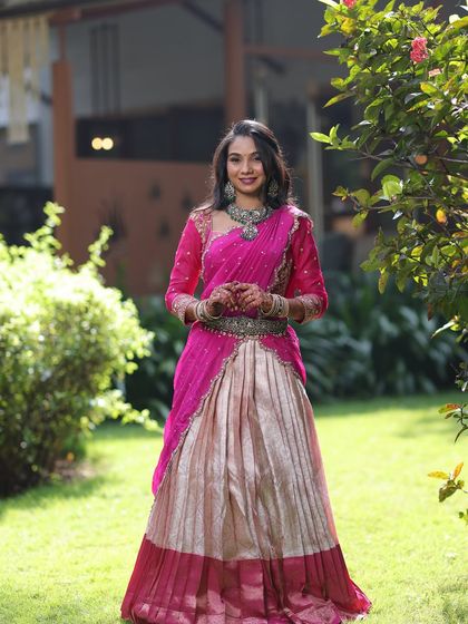 A full-length shot of Sanjana's beautiful outfit. The antique-silver-finish jewellery provides a stunning contrast to her vibrant pink attire.