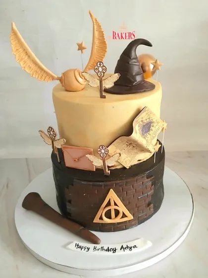 A magical two-tier Harry Potter cake for a young wizard's 8th birthday! This design was packed with details like the Sorting Hat, Golden Snitch, and flying keys, all handcrafted with minimal fondant. Both tiers were a rich dark chocolate, perfect for a magical feast.