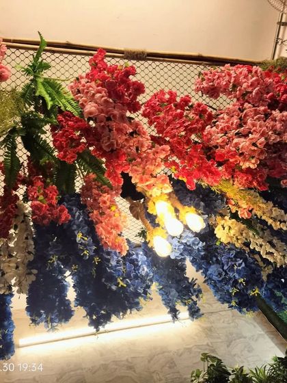 Another angle of the colorful floral ceiling. This type of installation is perfect for restaurants, event spaces, or any area where you want to make a bold and unforgettable design statement.