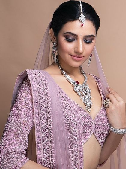 Our custom stitching service allows for breathtaking results. This lavender blouse features intricate beadwork and a modern deep V-neckline, perfectly tailored to create a stunning silhouette for a wedding or reception.