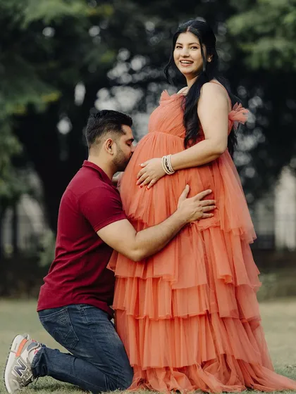 A kiss for the baby bump! These are the moments to cherish, and I'm so happy my rental outfits can be a part of them.