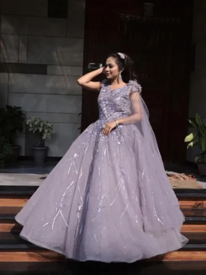 Feel like a princess in this lilac ball gown. The shimmering fabric and voluminous skirt create a magical effect, especially under evening lights. It's a true showstopper available for rent for your most important celebrations.