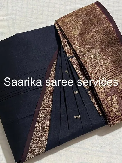 A classic black saree with a bronze-gold border.