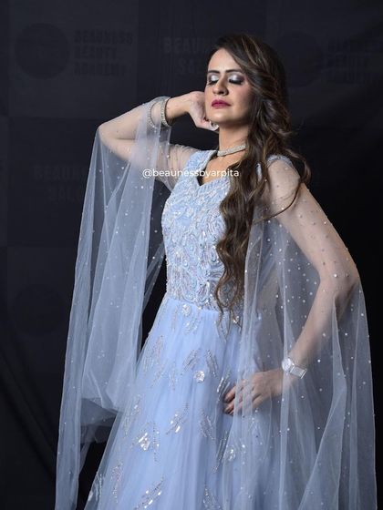 Feel like a princess in this powder blue gown with cape-like sleeves. The silver embroidery adds a touch of sparkle, making it perfect for a reception or engagement.