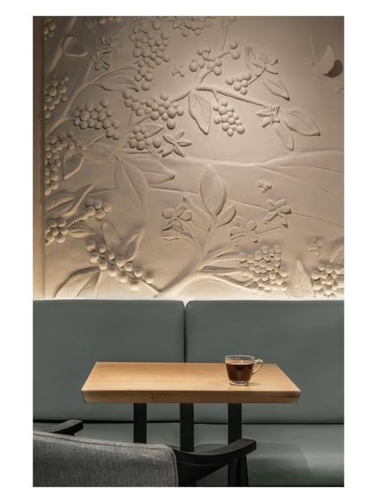 A closer view of the custom mural we commissioned from a local artist. The bas-relief sculpture celebrates the coffee plant, subtly nodding to the brand’s roots in Chikkamagaluru’s plantations.