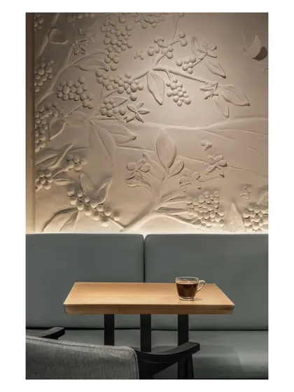 A closer view of the custom mural we commissioned from a local artist. The bas-relief sculpture celebrates the coffee plant, subtly nodding to the brand’s roots in Chikkamagaluru’s plantations.
