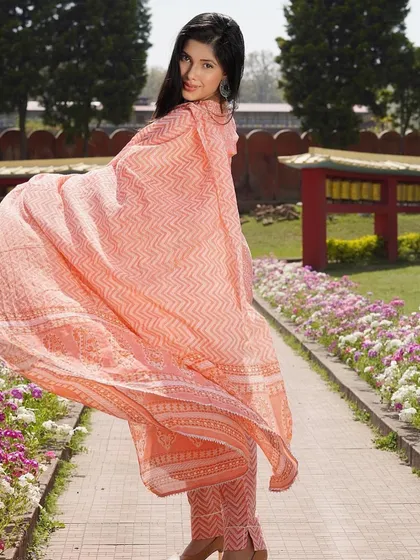 The flow of a soft cotton dupatta can make an entire outfit feel more elegant. This peach-colored suit with a geometric print is perfect for a sunny day, offering both style and comfort.
