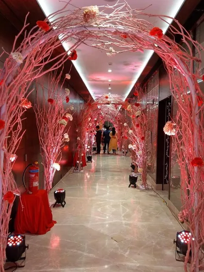 A magical pathway created with arches of painted branches and hanging flowers. This entrance tunnel sets a romantic and enchanting mood for guests as they arrive.