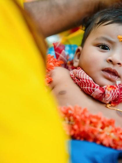 A close-up of the baby's expressive face during the ceremony. I love capturing their little reactions to the new sights and sounds.
