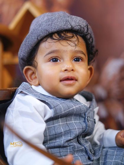 A dapper little gentleman. This vintage-themed sitter session with a plaid suit and a newsboy cap is timeless and classic.