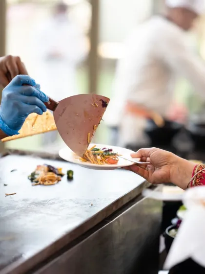 A plate being served fresh off the grill, a detail shot that highlights the catering and food experience at the event.