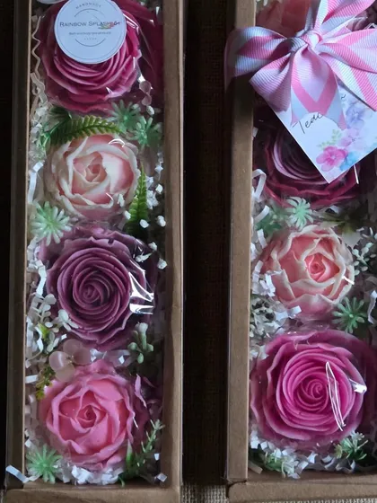 A set of four large, detailed flower soaps, beautifully packaged in a long gift box.