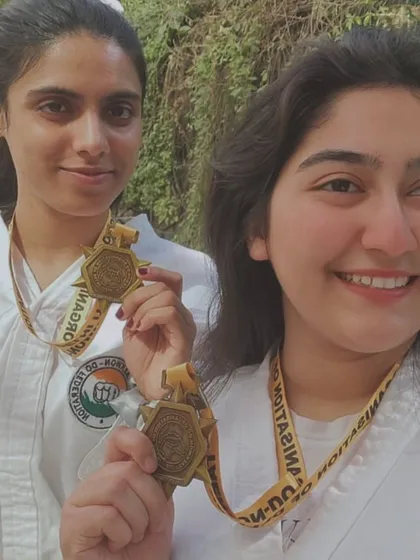 A close-up of two of our female champions and their hard-earned gold medals.