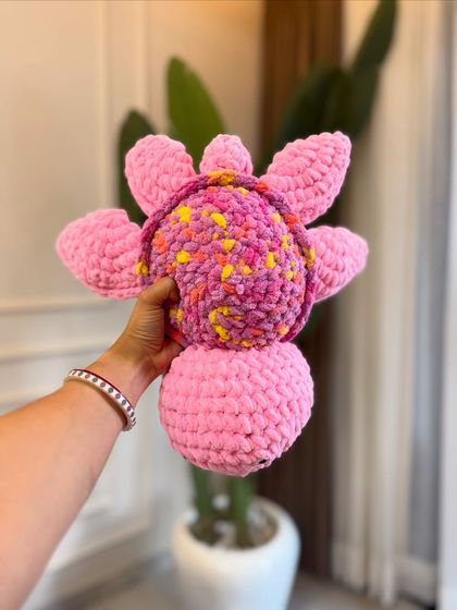 A close-up of the colorful shell on our crochet turtle. We use variegated yarn to give each turtle a unique, speckled pattern, making no two exactly alike.