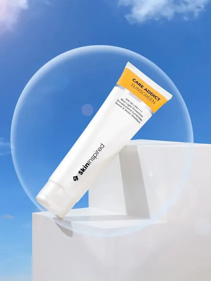 A creative studio shot for a sunscreen, using a clear acrylic bubble and a sky background to symbolize protection. This conceptual approach helps communicate the product's benefits in a visually interesting way.