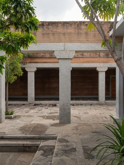 A view across the courtyard at the H.N. Science Center, where trees are planted within the paved area to provide shade and soften the stone architecture.