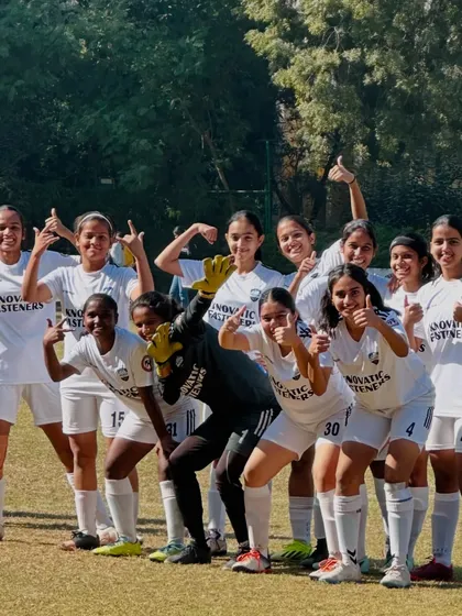 The SheWolves team poses for a group photo, all smiles after a game. This picture captures the camaraderie and positive spirit we foster within our girls' football program.
