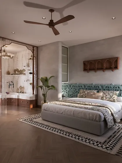This bedroom blends timeless Indian aesthetics with personal detailing. A carved turquoise bed-back anchors the space, while a dedicated mandir niche by the window adds a soulful dimension, bathed in natural light.